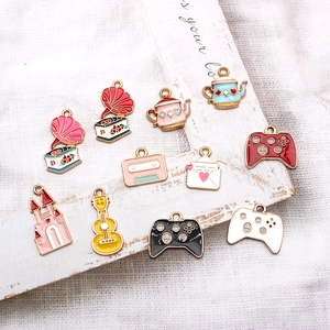 Collection of ten colorful enamel vintage charms including gramophone and game controller