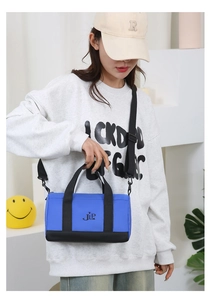 Blue nylon pillow bag shown with adjustable black strap and comfortable JLP logo detail