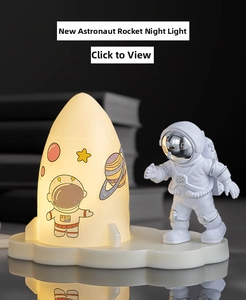 Detail of creative astronaut rocket night light with warm glow on a cloud base