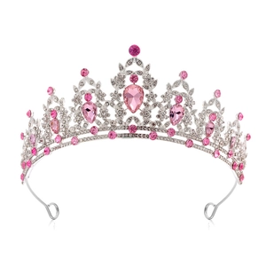 Detailed view of silver bridal crown with pink teardrop crystals and clear rhinestones