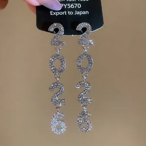 Sparkling silver 2026 fringe tassel earrings with full diamond pavé on elegant black card