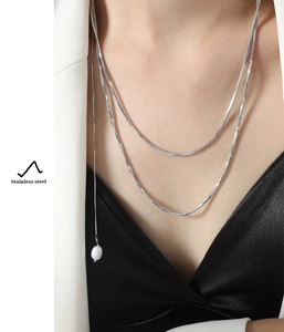 Double-layered stainless steel snake chain necklace with pearl pendant on model