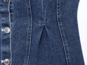 Detail of dark blue denim tube top with metallic buttons and high-quality stitching