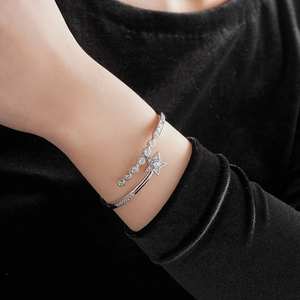Detail of silver star cuff bracelet with sparkling cubic zirconia on a model's wrist
