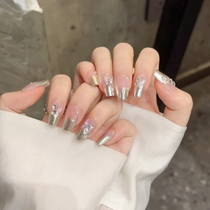 Silver mirror chrome press-on nails with 3D metal butterfly and glitter rhinestones