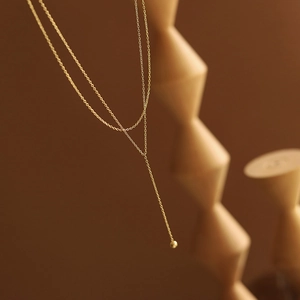 Minimalist 18K gold plated Y-shaped tassel necklace with small golden ball pendant