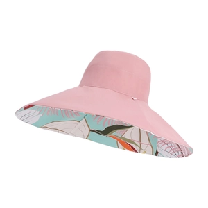Pink wide brim sun hat with tropical leaf print lining and reversible design for women