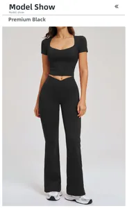 Premium black yoga set featuring U-neck crop top and high-waist flared pants on model