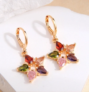 Macro view of gold-plated lucky star earrings featuring colorful zirconia drop stones