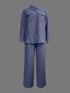 Detail of greyish blue two-piece set featuring pleated texture and classic collared shirt