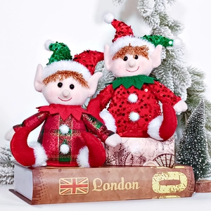 Detail of Christmas elf plush dolls with sequins on festive gift boxes background
