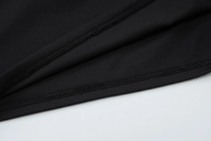 Detailed close-up showing the hem stitching and texture of the black knit summer skirt