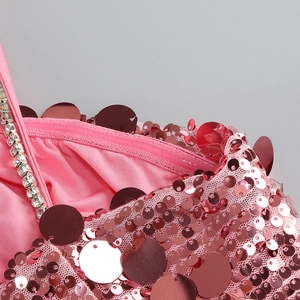 Detailed macro view of pink sequins with rhinestone strap and delicate mesh fabric texture