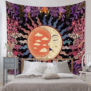 Detail of bohemian sun and moon tapestry with intricate floral patterns above a cozy bed
