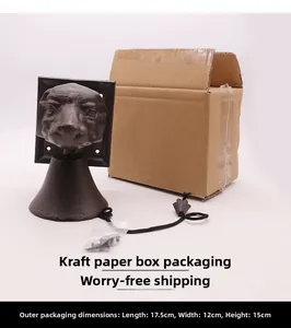 Rustic cast iron dog head doorbell with black cord and brown cardboard box packaging