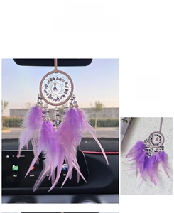 Detail view of purple crystal dreamcatcher car ornament with soft feathers and beads