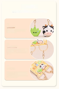 Macro detail of cartoon cow and grass keychain charms with zinc alloy gold lobster clasp