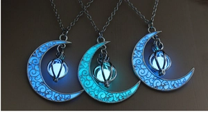 Luminous crescent moon necklace with blue glowing stone and silver pumpkin cage pendant