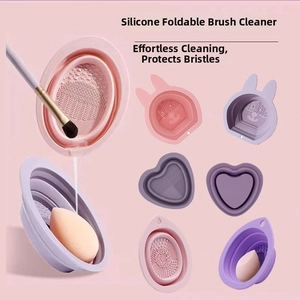 Foldable silicone makeup brush cleaning bowl with multiple textured surfaces in pastel colors