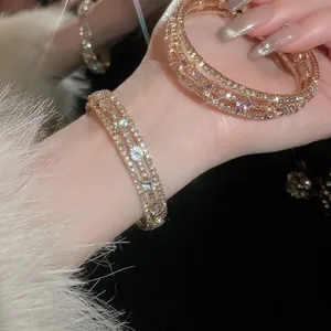 Elegant triple-layer gold bracelet featuring sparkling zircons and lavender stones