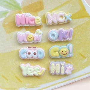 Close-up of colorful resin alphabet charms with words like Good and Nice for DIY crafts