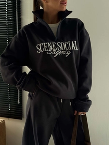 Detail of the high collar half-zip sweatshirt with white embroidery SCENE SOCIAL Agency