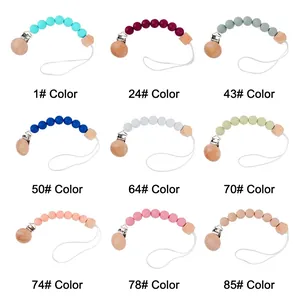 Silicone and beech wood baby pacifier clips in nine colors on a white background