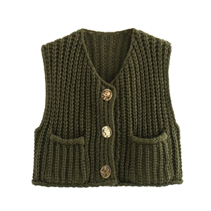 Detail of dark green knit vest featuring V-neckline and three textured buttons on front