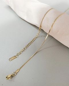 Close-up of golden stainless steel necklace with lobster clasp and S.STEEL engraving