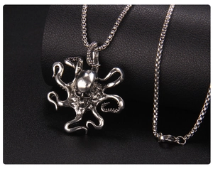 Detailed close-up of a silver octopus skull pendant with a durable metal box chain