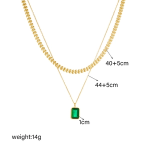 Double layer gold necklace featuring a wheat leaf chain and emerald square gem pendant