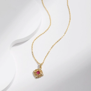 Retro S925 silver necklace with red square stone and diamond accents on white waves