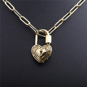 Golden hip hop heart lock pendant necklace with zircon accents on a long oval chain