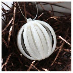 Macro detail of champagne hollow glitter lantern ball ornament with silver string