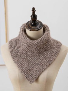 Detail of chunky ribbed knit scarf on mannequin showing soft thick brown wool texture