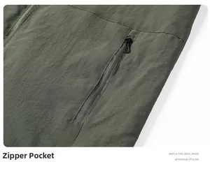 Detail of army green outdoor jacket featuring a high-quality zipper pocket with puller