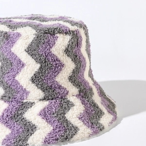 Fuzzy wave pattern bucket hat with purple and white knit faux fur texture
