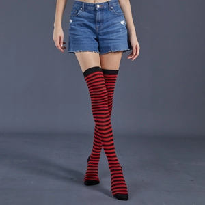 Detail of red and black striped over-the-knee socks showing tight knit fabric texture