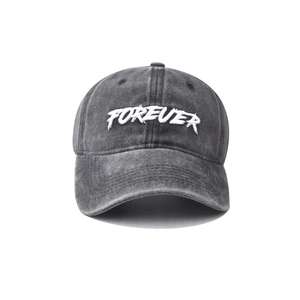Detailed close-up of FOREVER white embroidery on a washed dark grey cotton baseball cap