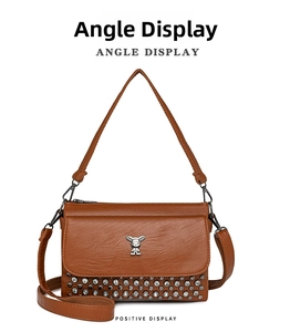 Front view of brown leather crossbody bag with cartoon bunny logo and rhinestone detail