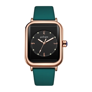 Detail view of square quartz watch featuring a blue gemstone crown and rose gold case