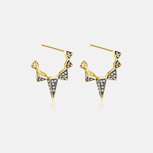 Macro detail of geometric triangle earrings with black inlay and pavé micro-set cubic zirconia