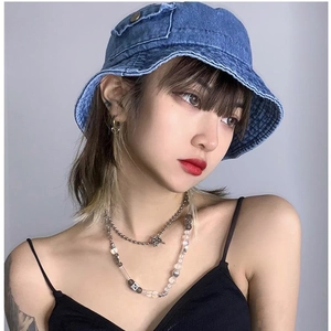 Chic blue denim bucket hat for sun protection shown on a model in street style