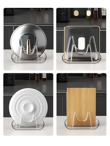 Detail of transparent kitchen lid organizer with U-shaped slots for lids and boards