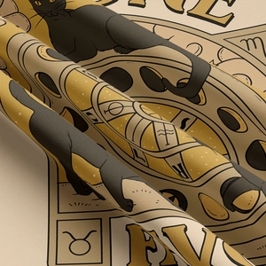 Close-up of fine fabric texture and cat tarot print on the decorative wall tapestry