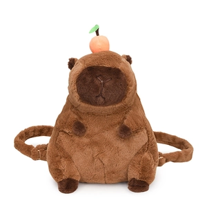 Cute brown capybara plush backpack with orange fruit detail on white background