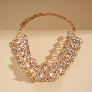 Macro detail of geometric hollow necklace with rose gold finish and sparkling rhinestones
