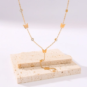 Elegant 18K gold butterfly necklace with zircon pendants on a minimalist Y-chain style