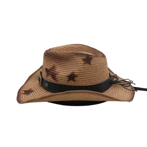 Detail of western straw hat with five-point star rivets and black leather band decoration