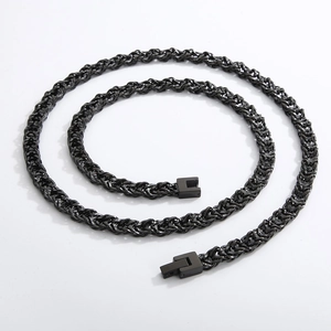 Detail of black woven titanium steel chain with a square clasp on a white background